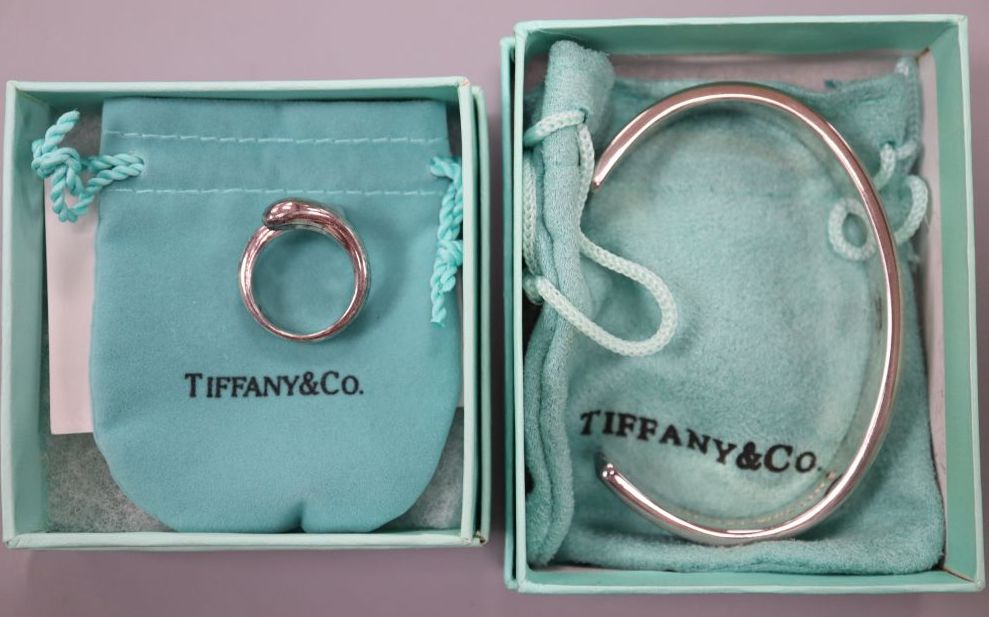 A modern Tiffany and Co 925 snake ring, size M and a Tiffany & Co 925 bangle, both with pouch and box.